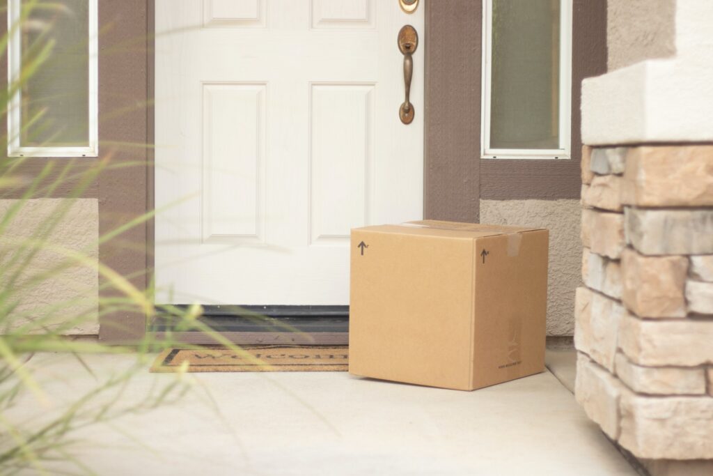 Image of a front porch with a cardboard box from a parcel delivery